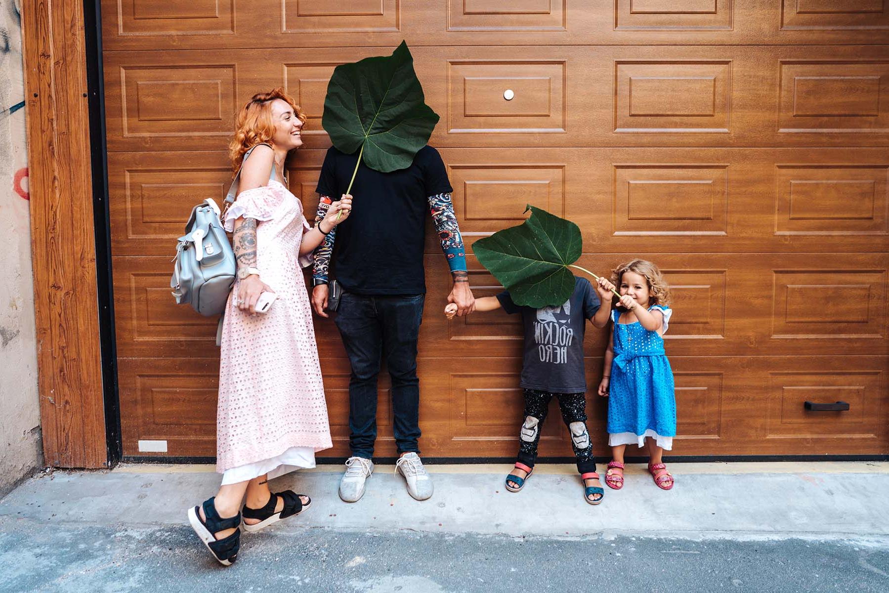 A family standing outside of a garage door